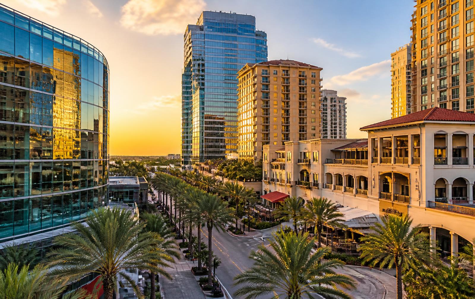 Downtown West Palm Beach commercial district with glass office towers and palm-lined Clematis Street